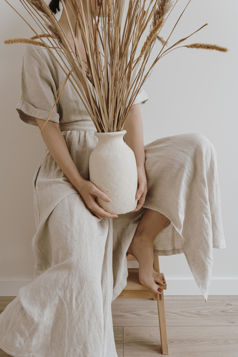 Woman Holding a Flower Vase