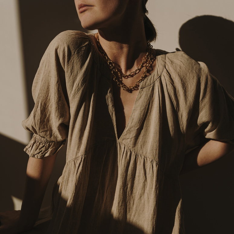 Woman in Brown Dress and Necklace